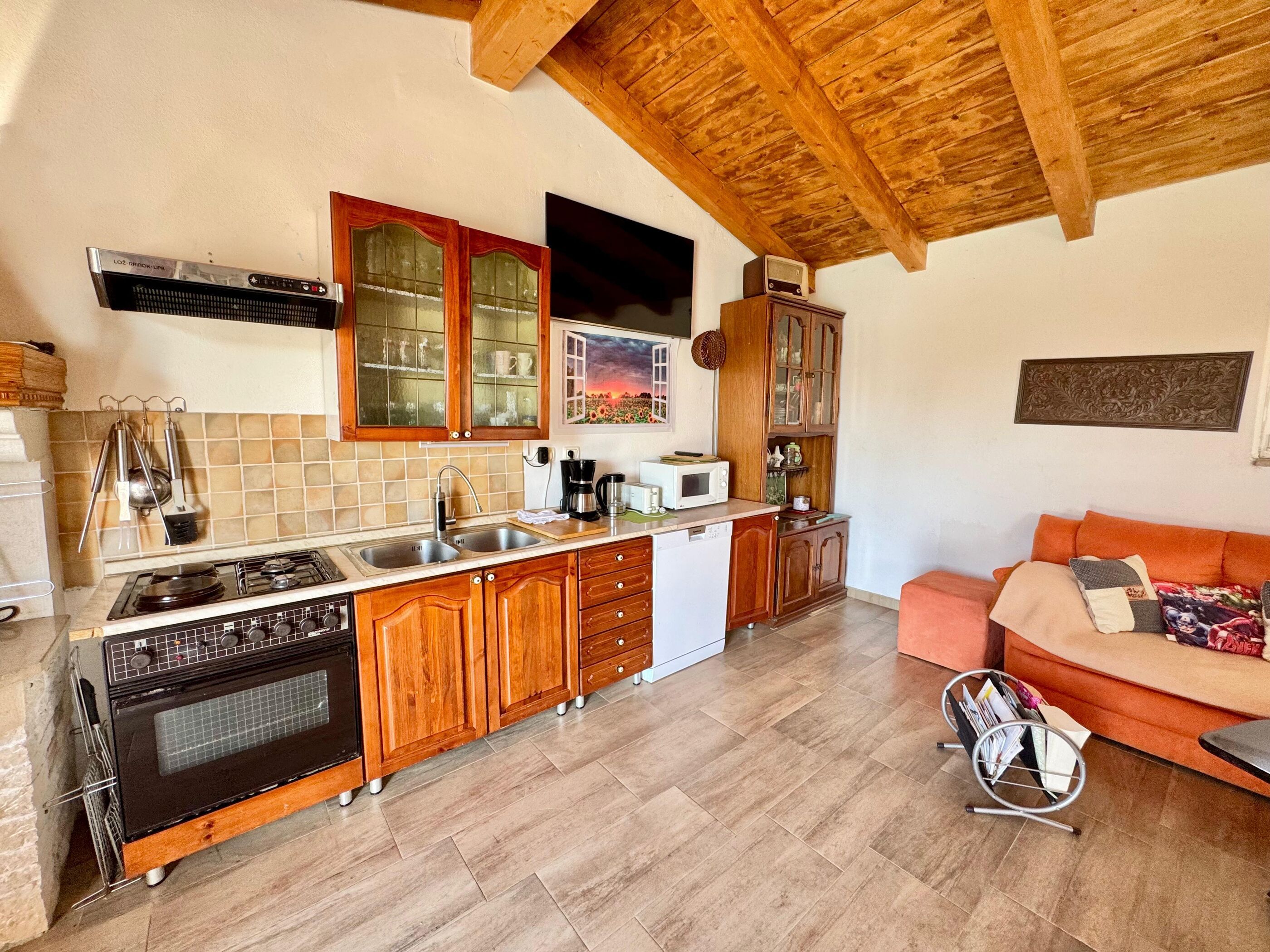 A kitchen with wooden cabinets, a stove, and a microwave.