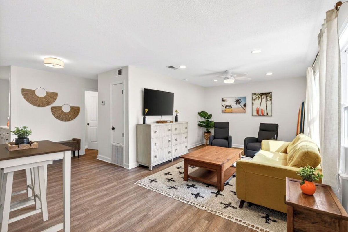 A modern living room with a sofa, coffee table, and TV.