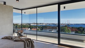 A modern bedroom with a large window, a bed, and a view of a cityscape. - Villa Aquarius (74198-K1) - Pula (Pula)