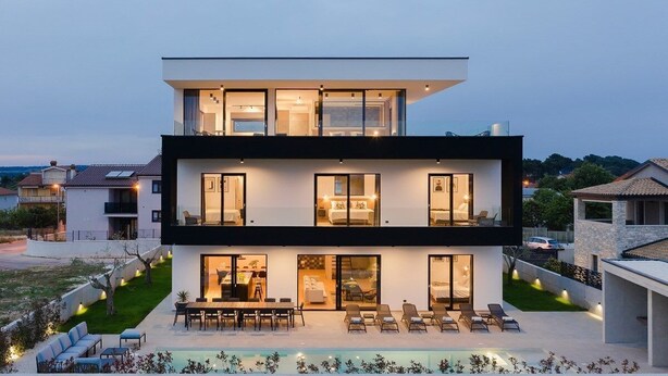 A modern two-story house with a swimming pool, outdoor seating, and a well-lit interior. - Villa Aquarius (74198-K1) - Pula (Pula)
