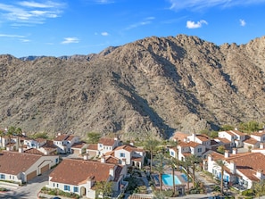 A residential area with white houses, red-tiled roofs, and a mountain backdrop. - Family Friendly Legacy Villas Retreat- Mountain Views (La Quinta)
