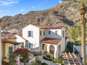 A residential area with white buildings, red-tiled roofs, and a mountainous backdrop. - Family Friendly Legacy Villas Retreat- Mountain Views (La Quinta)