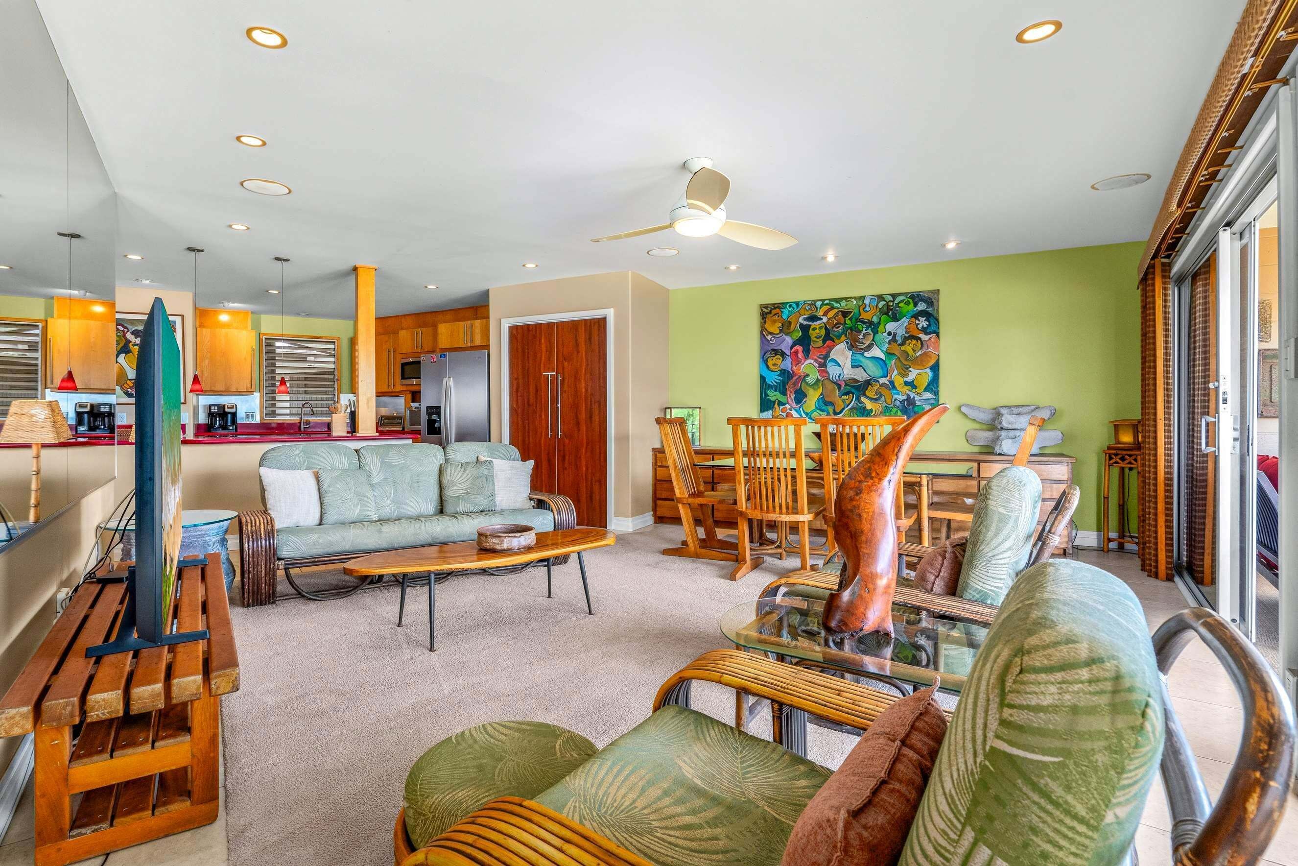 A modern living room with a sofa, chairs, a coffee table, and a dining area with chairs and a table.