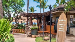 A beach house with a wooden sign listing breakfast, lunch, dinner, and cocktails. - Honua Kai Resort Konea 505 Ocean & Sunset View 2BR at Kaanapali (Lahaina)