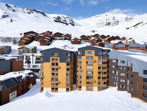 A snow-covered mountain resort with multiple wooden and modern buildings. - (CD-1304) Val Thorens - Ski In/Out - 5 Beds Flat (Les Belleville)