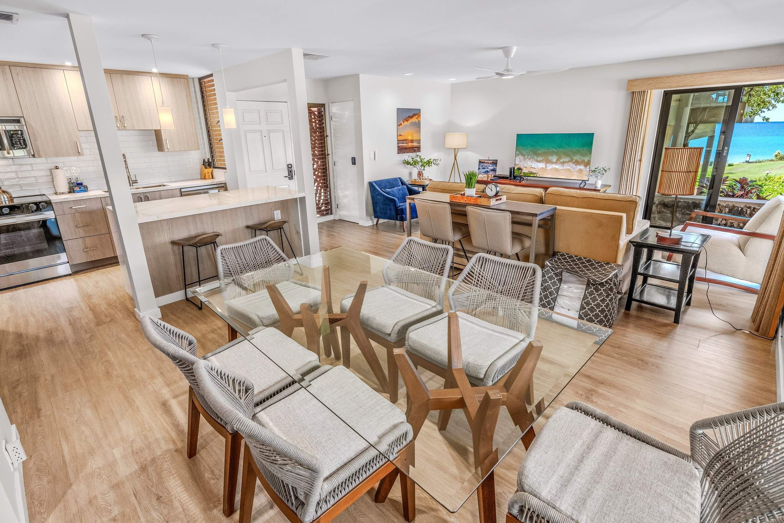 A modern open-plan living space with a kitchen, dining area, and seating area.
