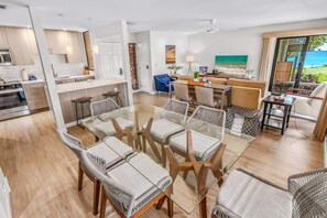 A modern open-plan living space with a kitchen, dining area, and seating area. - Luxurious Oceanfront Condo at Wailea Elua Village - Unit 1201, Central AC, Wi-fi (Kihei)