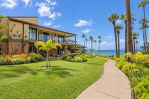 A modern hotel with a pool area, palm trees, and a view of the ocean. - Luxurious Oceanfront Condo at Wailea Elua Village - Unit 1201, Central AC, Wi-fi (Kihei)