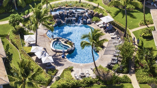 An aerial view of a resort with a central swimming pool surrounded by palm trees and lounge areas. - New Listing! Honua Kai Luana Garden Villas 7B - Ground Level, Private Lanai, BBQ (Lahaina)