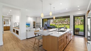 A modern kitchen with a large island, wooden cabinets, and pendant lighting. - New Listing! Honua Kai Luana Garden Villas 7B - Ground Level, Private Lanai, BBQ (Lahaina)