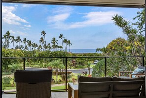 A balcony with a view of palm trees and the ocean. - Wailea Elua 803 - Ocean Views, Modern Renovation, Central AC, Wi-fi, BBQ Grill (Kihei)