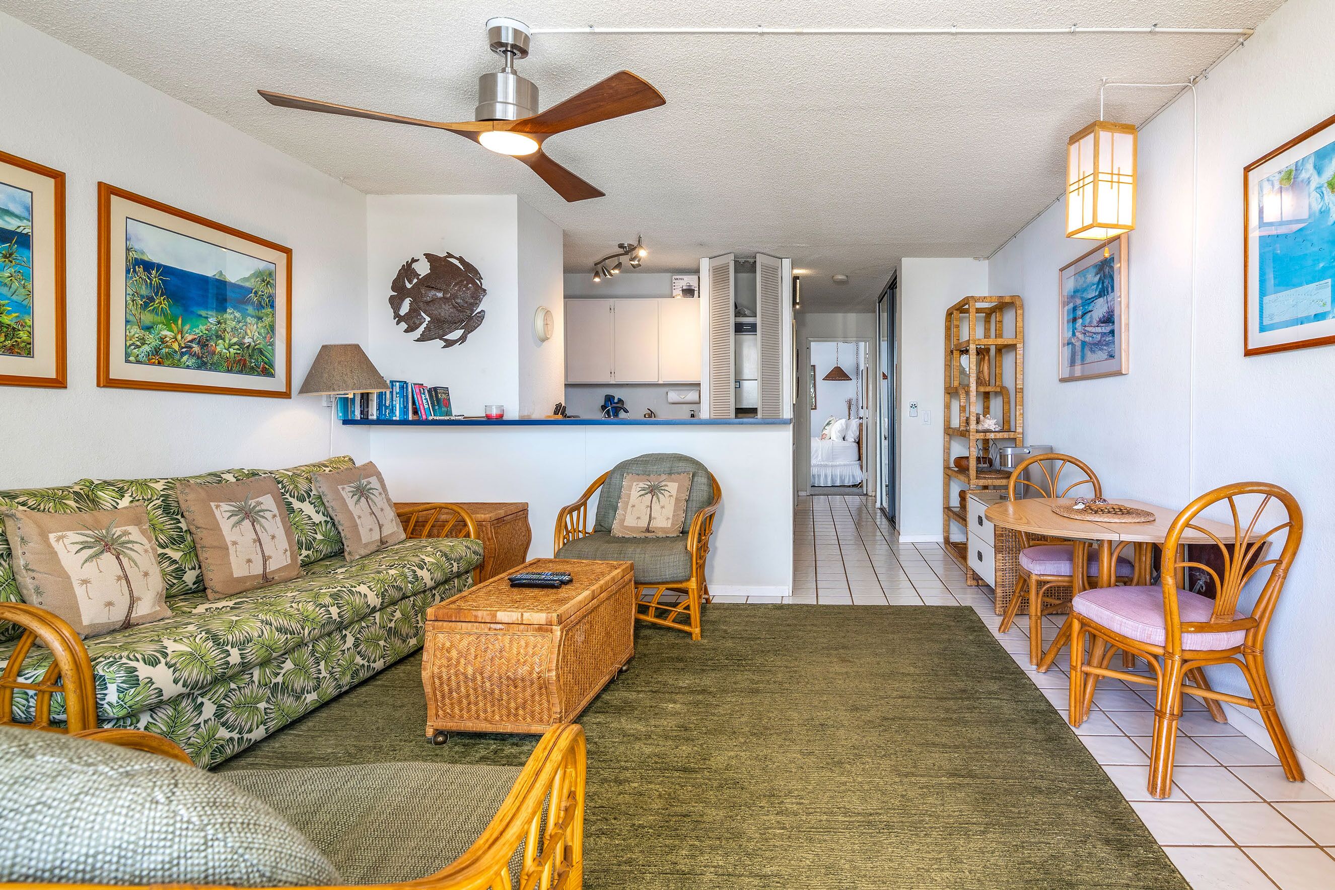 A living room with a sofa, chairs, a coffee table, and a dining area with a table and chairs.