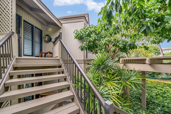 A staircase leading to a house with a porch, surrounded by greenery. - Extraordinary Molokini Views, Spectacular Renovation, New Split AC, Ocean Views! (Kihei)