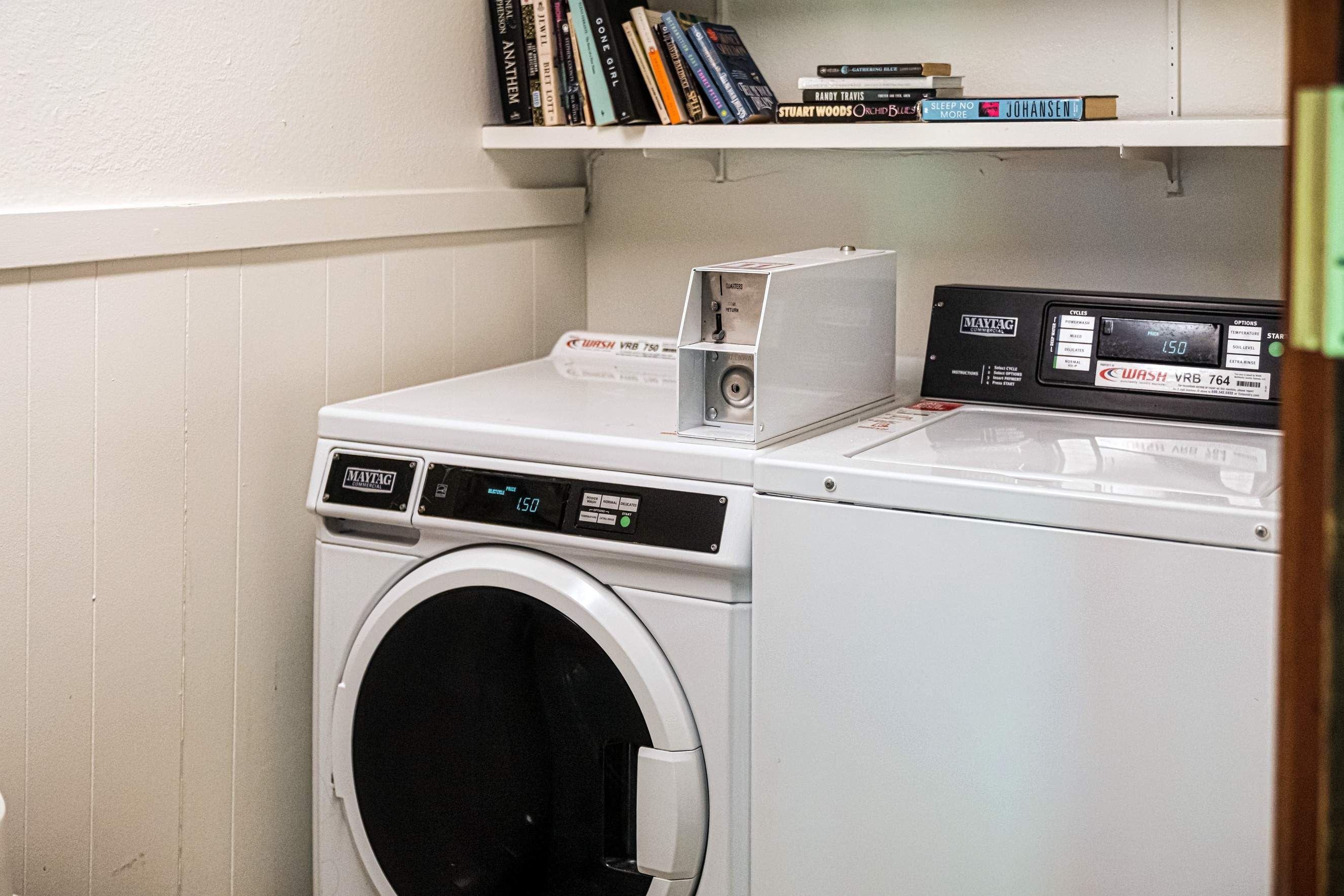 A front-loading washing machine with a control panel and a digital display.