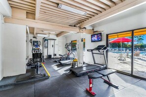 A gym with treadmills, stationary bikes, and a weight bench. - Kamaole Sands 2-204 - Dramatic Ocean and Courtyard Views, 1bd / 2ba, AC, Wi-fi (Kihei)