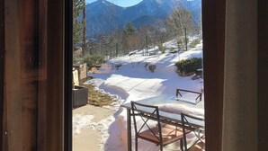 A view from inside a building looking out to a snowy landscape with mountains in the distance. - A B&B in the heart of Chalet Mitja, calm and well-being guaranteed! (La Cabanasse)