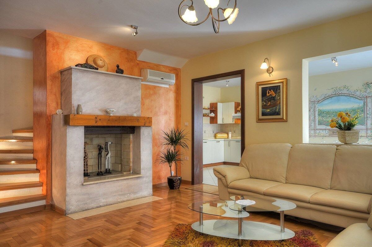 A living room with a fireplace, sofa, and coffee table.