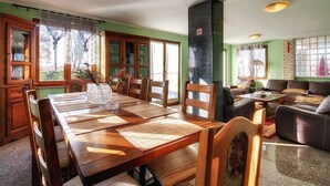 A dining area with a wooden table and chairs, a sofa, and a fireplace. - Villa Fatima (V3497-K1) - Krnica (Pula) (Krnica (Pula))