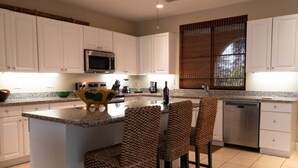 A kitchen with white cabinets, a microwave, a coffee maker, and a dishwasher. - Cozy 1BDR Condo pool front in Playas del Coco (Coco)