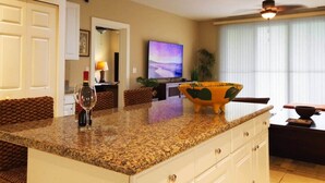 A kitchen with granite countertops, a wine glass, and a decorative bowl. - Cozy 1BDR Condo pool front in Playas del Coco (Coco)