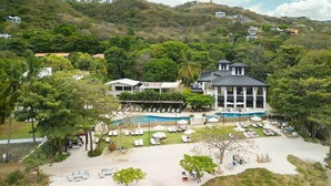A resort with multiple pools, sun loungers, and a large building with a swimming pool. - Wake Up in Paradise, Amazing 3BDR Condo Near Beach (Coco)