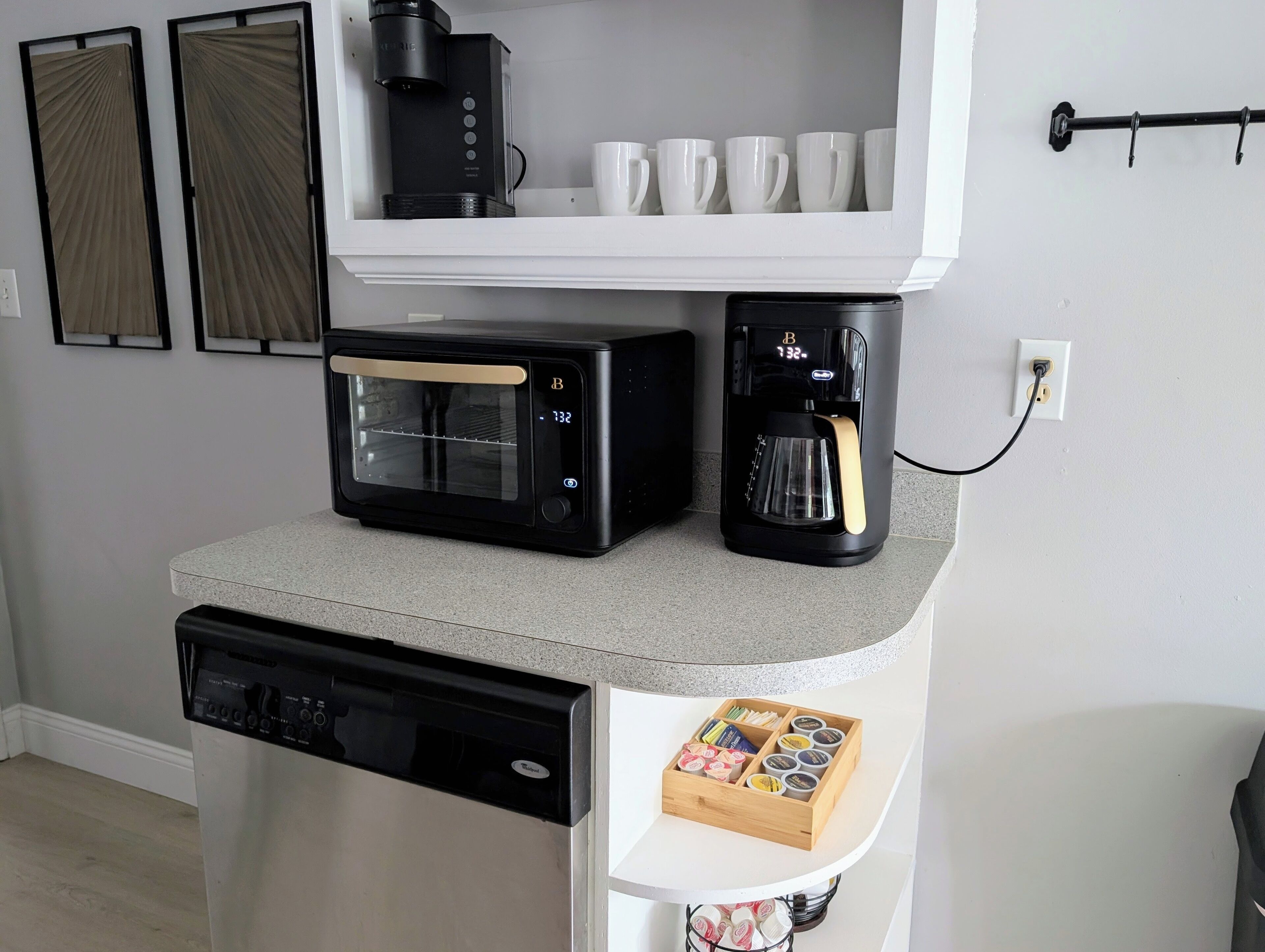 A kitchen with a coffee maker, toaster, and dishwasher.