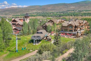 A lodge with multiple buildings, a ski lift, and a dining area with outdoor seating. - Elegant 4BR Home w/ Fireplace & Mountain Views (Edwards)
