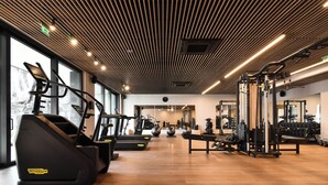 A gym with treadmills, exercise balls, and weight machines. -  Hayashi Residence (Sofia)