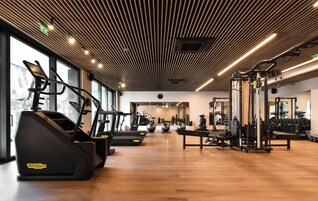 A gym with treadmills, exercise balls, and weight machines.