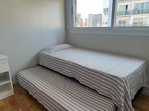A small, single-bed room with a window overlooking a cityscape. - -Belgrano- (Buenos Aires)