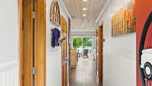 A hallway with wooden doors, a radiator, and a painting on the wall. - 3-bedroom waterfront cottage with unmatched views and dock on Tennessee River (Decatur)