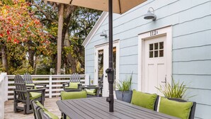 A deck with outdoor seating, including tables and chairs, and a house number 112A visible on the building. - Beach Maverick - 3 BR 2 Bath 1 Block to Center St! (Folly Beach)