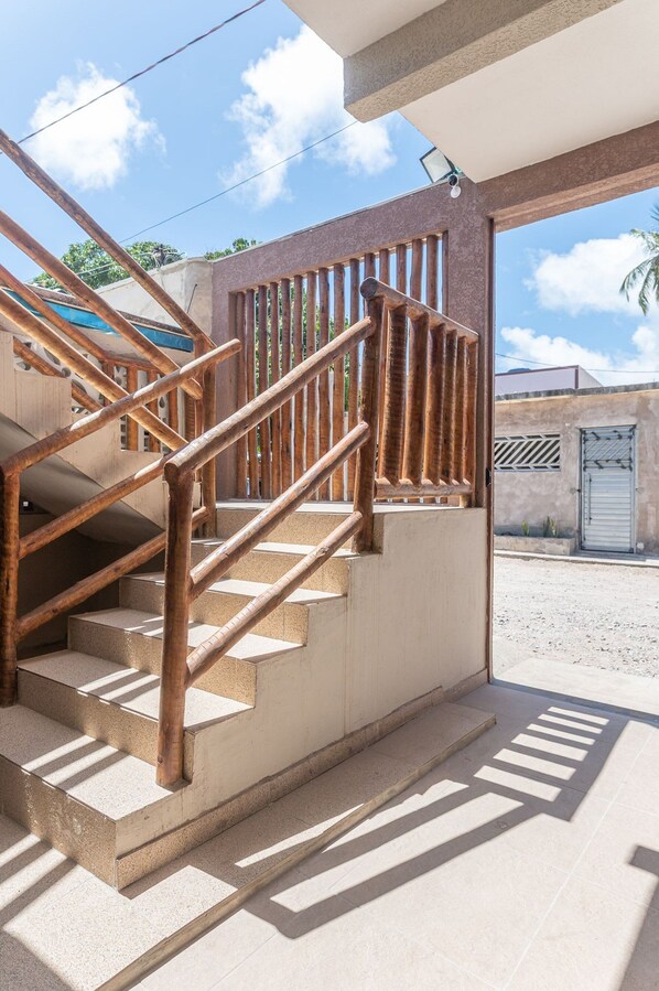 A staircase with wooden railings leading to an open doorway.
