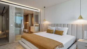 A modern hotel room with a large bed, a walk-in closet, and a bathroom with a bathtub. - Lyra Luxury Savoy Monumentalis by LovelyStay (Funchal)