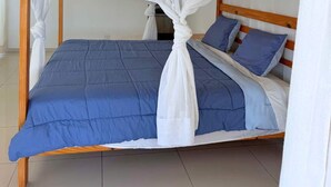 A bed with a blue mattress and white canopy.