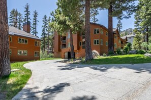 A multi-story building with a brick exterior and multiple windows. - Shared Hot Tub and Pool | Mountain Views (Mammoth Lakes)