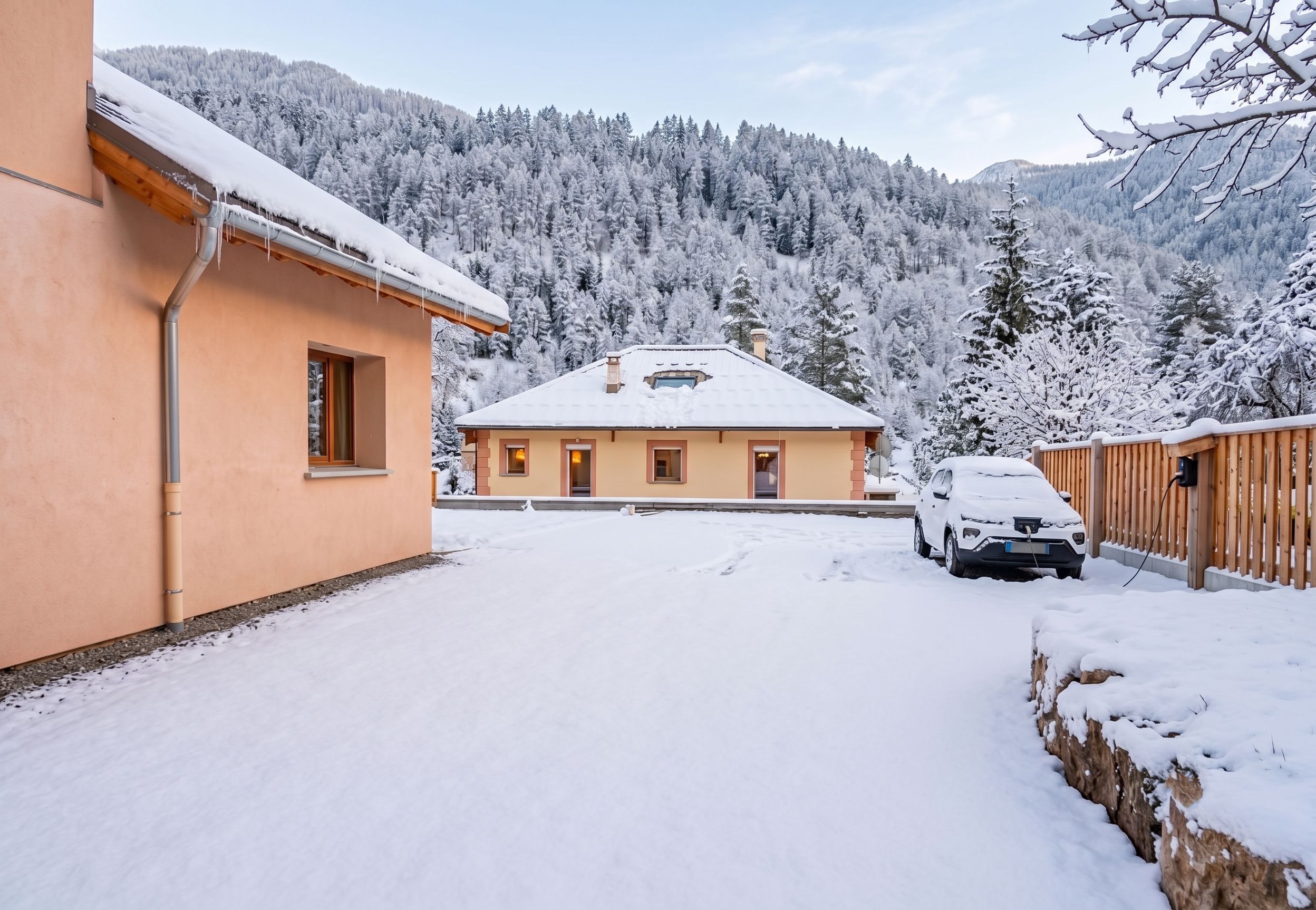 A snow-covered building with a car parked in front.