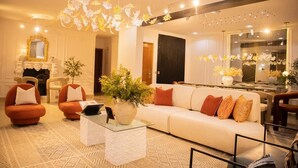 A modern living room with a white sofa, orange armchairs, and a glass coffee table. - 3 Bedroom En-Suite, Wi-Fi, Secured, 24/7 Power (Lagos)