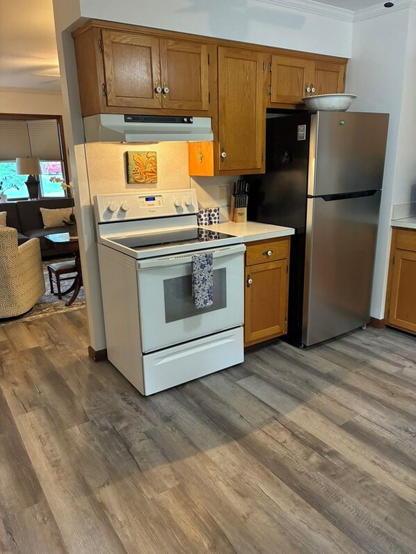 A kitchen with wooden cabinets, a stainless steel refrigerator, and a white stove. - Brand new listing 1 mile from the quaint villages of Marblehead & Lakeside (Lakeside)