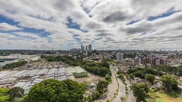 A cityscape with a prominent industrial area, a curved road, and a mix of residential and commercial buildings.