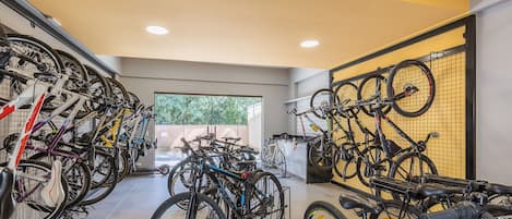 A bike storage area with multiple bicycles secured on racks.