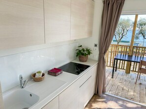 Fridge, coffee/tea maker, high chair, cookware/dishes/utensils