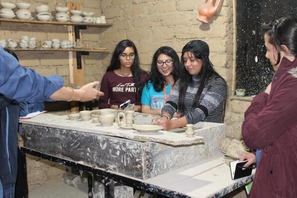 A pottery workshop with participants engaged in pottery making.