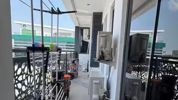 A narrow balcony with a gym setup, including a pull-up bar and exercise equipment. - 3 Bedroom En-Suite, Wi-Fi, Secured, 24/7 Power (Lagos)