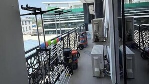 A balcony with exercise equipment, a water dispenser, and a view of the cityscape. - 3 Bedroom En-Suite, Wi-Fi, Secured, 24/7 Power (Lagos)