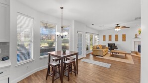 A spacious living room with a wooden floor, a sofa, a coffee table, and a fireplace. - Family Friendly Hurst Home with Salwater Poo,l Fireplace, and Spacious Layout (Hurst)