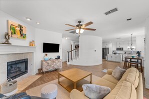 Smart TV, fireplace, books, computer monitors