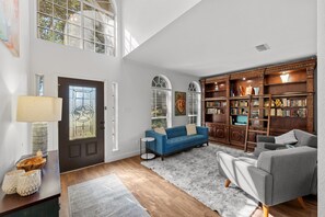 Smart TV, fireplace, books, computer monitors