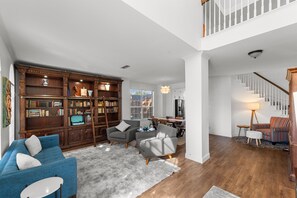 Smart TV, fireplace, books, computer monitors