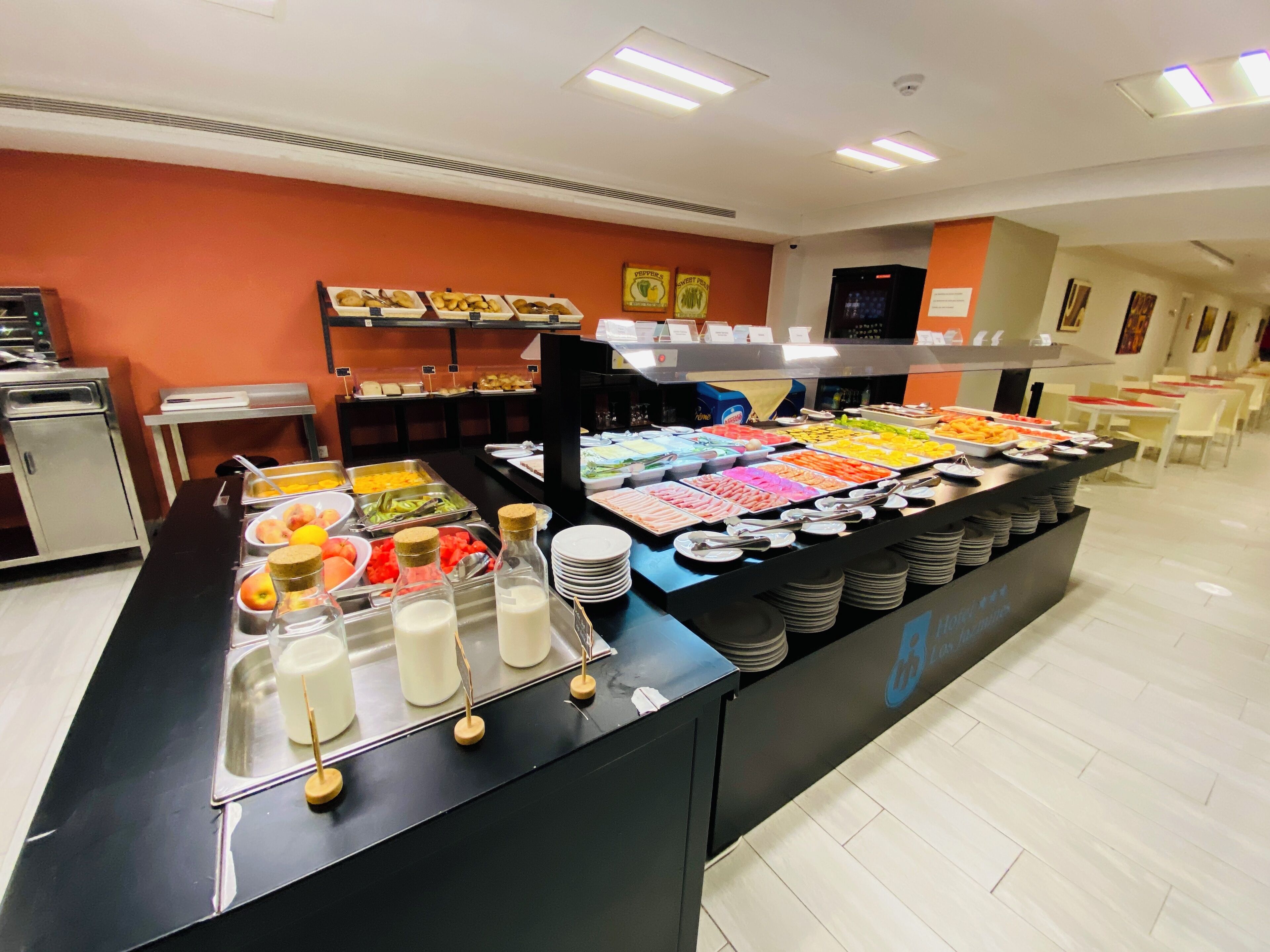 A buffet with various food items and beverages.